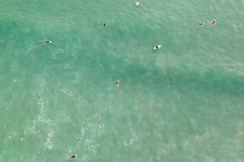 Aerial view of Surfers waiting for the wave in front of the Plage de Tronoën in Saint-Jean-Trolimon in the state Finistere, France