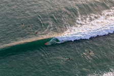 Wave surfers in front of the Plage de Tronoën/Bretagne in Saint-Jean-Trolimon in the state Finistere, France