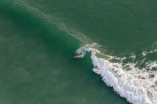 Drone recording of Wave surfers in front of the Plage de Tronoën in Saint-Jean-Trolimon in the state Finistere, France