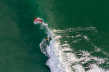 Aerial view of Wave surfers in front of the Plage de Tronoën/Bretagne in Saint-Jean-Trolimon in the state Finistere, France