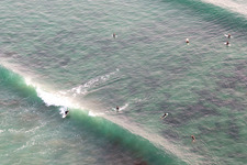 Aerial photograpy of Wave surfers in front of Plage la Torche-Tronoën in Saint-Jean-Trolimon in the state Finistere, France