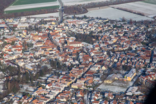 Main street with parish church of St. Michael in winter with snow in Rheinzabern in the state Rhineland-Palatinate, Germany
