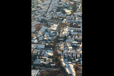 Aerial view of Braun Foundation and St. Mauritius Church in winter with snow in Rülzheim in the state Rhineland-Palatinate, Germany