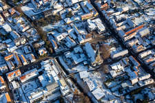 Aerial view of St. Mauritius Church in winter with snow in Rülzheim in the state Rhineland-Palatinate, Germany