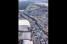 Litzelhorststraße in winter with snow in Herxheim bei Landau in the state Rhineland-Palatinate, Germany