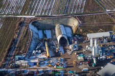 Construction site of the tunnel portal east for the Astrid Tunnel for the underpass and bypass of Bad Bergzabern between B38 (Weinstraße) and B427 (Kurtalstraße) in winter with snow in Dörrenbach in the state Rhineland-Palatinate, Germany from above