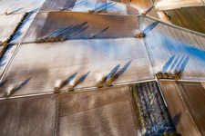 Aerial view of Field structures and shadows in winter with snow in Vollmersweiler in the state Rhineland-Palatinate, Germany