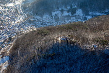 Ramburg castle ruins in winter with snow in Ramberg in the state Rhineland-Palatinate, Germany from above