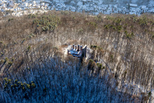 Ramburg castle ruins in winter with snow in Ramberg in the state Rhineland-Palatinate, Germany out of the air