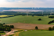 Aerial view of Czech wind farm Wetzwalde (Větrný park Václavice) in front of the Polish brown coal open-cast mine Kopalnia Węgla Brunatnego Turów in Hrádek nad Nisou in the state Liberec, Czech Republic