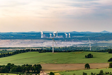 Oblique view of Czech wind farm Wetzwalde (Větrný park Václavice) in front of the Polish brown coal open-cast mine Kopalnia Węgla Brunatnego Turów in Hrádek nad Nisou in the state Liberec, Czech Republic