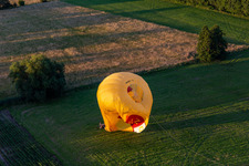 Bird's eye view of Landing of two hot air balloons "Pfalzgas in Winden in the state Rhineland-Palatinate, Germany