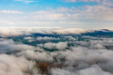 Village on the edge of the Pfläzerwald from the southeast under low clouds in Klingenmünster in the state Rhineland-Palatinate, Germany