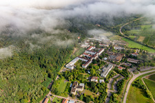 Dense clouds over the Palatinate Hospital for Psychiatry and Neurology in Klingenmünster in the state Rhineland-Palatinate, Germany from the plane