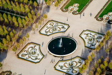 Flowers and spring fountain in the center of the park of the baroque castle Schloss Schwetzingen in Schwetzingen in the state Baden-Wurttemberg