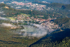 Village in the morning mist from the east in Schindhard in the state Rhineland-Palatinate, Germany