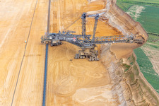 Oblique view of Giant hoisting crane eats into former farmland for the western expansion of the Garzweiler open-cast lignite mine in the district Immerath in Erkelenz in the state North Rhine-Westphalia, Germany
