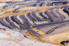 Interestingly colored layers of overburden and coal in the Garzweiler opencast lignite mine in the district Borschemich in Erkelenz in the state North Rhine-Westphalia, Germany out of the air