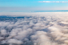Rotors of the wind farm near Offenbach rise above the low clouds in Offenbach an der Queich in the state Rhineland-Palatinate, Germany