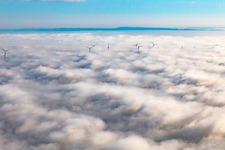 Aerial view of Rotors of the wind farm near Offenbach rise above the low clouds in Offenbach an der Queich in the state Rhineland-Palatinate, Germany