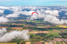 Paraglider over the Billigheimer Bruch in clouds in Winden in the state Rhineland-Palatinate, Germany