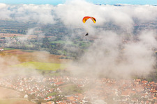 Aerial view of Village with paraglider under autumn clouds in Steinweiler in the state Rhineland-Palatinate, Germany