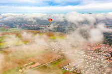 Aerial photograpy of Village with paraglider under autumn clouds in Steinweiler in the state Rhineland-Palatinate, Germany