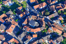 Aerial photograpy of Eglise protestante luthérienne as a fortified church surrounded by a circle of houses in Dossenheim-sur-Zinsel in the state Bas-Rhin, France