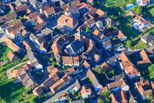 Oblique view of Eglise protestante luthérienne as a fortified church surrounded by a circle of houses in Dossenheim-sur-Zinsel in the state Bas-Rhin, France