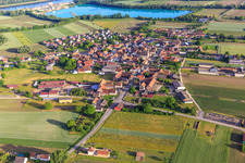 Aerial view of Village view from the north in front of the quarry lake/gravel works of Les Gravières Rhénanes SAS in Friesenheim in the state Bas-Rhin, France