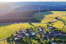 Village view from the east with two wind turbines in the district Äußerer Vogelsberg in Loßburg in the state Baden-Wuerttemberg, Germany