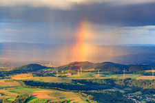Oblique view of Wind farm Merchingen in front of a rain wall with rainbow in the district Merchingen in Merzig in the state Saarland, Germany