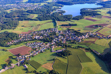 View of the village from the southwest in front of the Bostalsee biotope in the district Neunkirchen in Nohfelden in the state Saarland, Germany