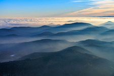 Hills of the Palatinate Forest and the Northern Vosges Mountains in the evening mist in Silz in the state Rhineland-Palatinate, Germany