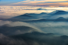 Panorama of the Palatinate Forest and the Northern Vosges Mountains in the evening haze - in the foreground the Stäffelsberg Tower in Klingenmünster in the state Rhineland-Palatinate, Germany