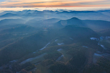 Palatinate Forest and Northern Vosges Mountains in the evening haze in Erlenbach bei Dahn in the state Rhineland-Palatinate, Germany
