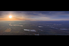 Sunset in the mist beyond the B9 highway above the Scheller Weiher pond, polytunnels belonging to P.+H. Fehmel Gemüsebau - FeSa Obst- & Gemüsehandels GmbH. in Mutterstadt in the state Rhineland-Palatinate, Germany