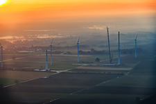 Sunset during the repowering of wind farm Minfeld. JUWI is replacing four old turbines (GE 1.5) from 2004 with two new, modern Vestas V162 turbines, each with a capacity of six MW. in Minfeld in the state Rhineland-Palatinate, Germany