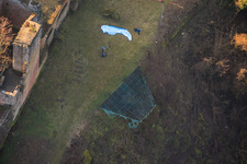 Paraglider pilots preparing for takeoff at the hang-gliding ramp below Madenburg Castle in Eschbach in the state Rhineland-Palatinate, Germany