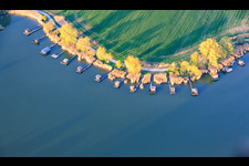 Boardwalks with fishing huts line the shore of Lake Etang du Welschhof. in Puttelange-aux-Lacs in the state Moselle, France