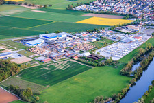Industrial park on the banks of the Main River with Reitz GmbH sawmill and GODELMANN GmbH & Co. KG concrete plant. in Wonfurt in the state Bavaria, Germany