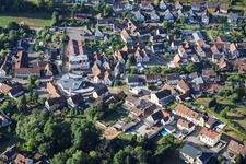 Modern church building of St. Sebastian and country inn Zur Linde in the village center in Silz in the state Rhineland-Palatinate, Germany
