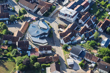 Modern church building of St. Sebastian and country inn Zur Linde in the village center in Silz in the state Rhineland-Palatinate, Germany