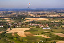 Paraglider over the village viewed from the northeast in Seebach in the state Bas-Rhin, France