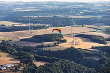 Paraglider in front of the wind farm at Einöderwiesenhof in Riedelberg in the state Rhineland-Palatinate, Germany