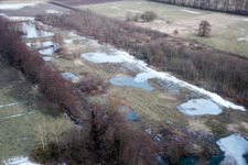 Aerial view of Wintry snowy Ponds and Morast- water surface in a pond landscape in Minfeld in the state Rhineland-Palatinate