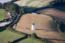 Historic windmill on the edge of cultivated fields in Whilborough in England, United Kingdom