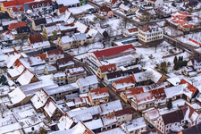 Village square with primary school in snow in Freckenfeld in the state Rhineland-Palatinate, Germany
