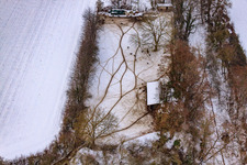 Game reserve at the Gasthaus zur Brauerei in snow in Freckenfeld in the state Rhineland-Palatinate, Germany seen from above
