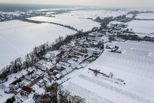 Wintry snowy Village - view on the edge of agricultural fields and farmland in Vollmersweiler in the state Rhineland-Palatinate, Germany